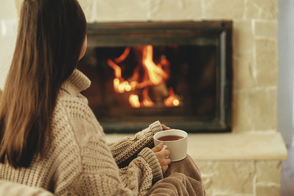 Woman in front of wood burning stove